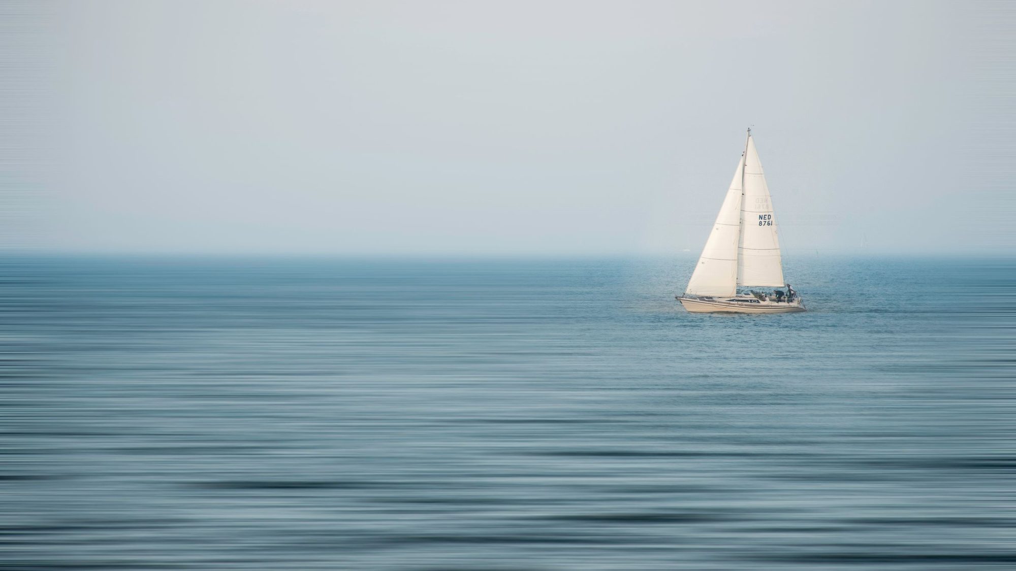 A sailing boat on calm open water
