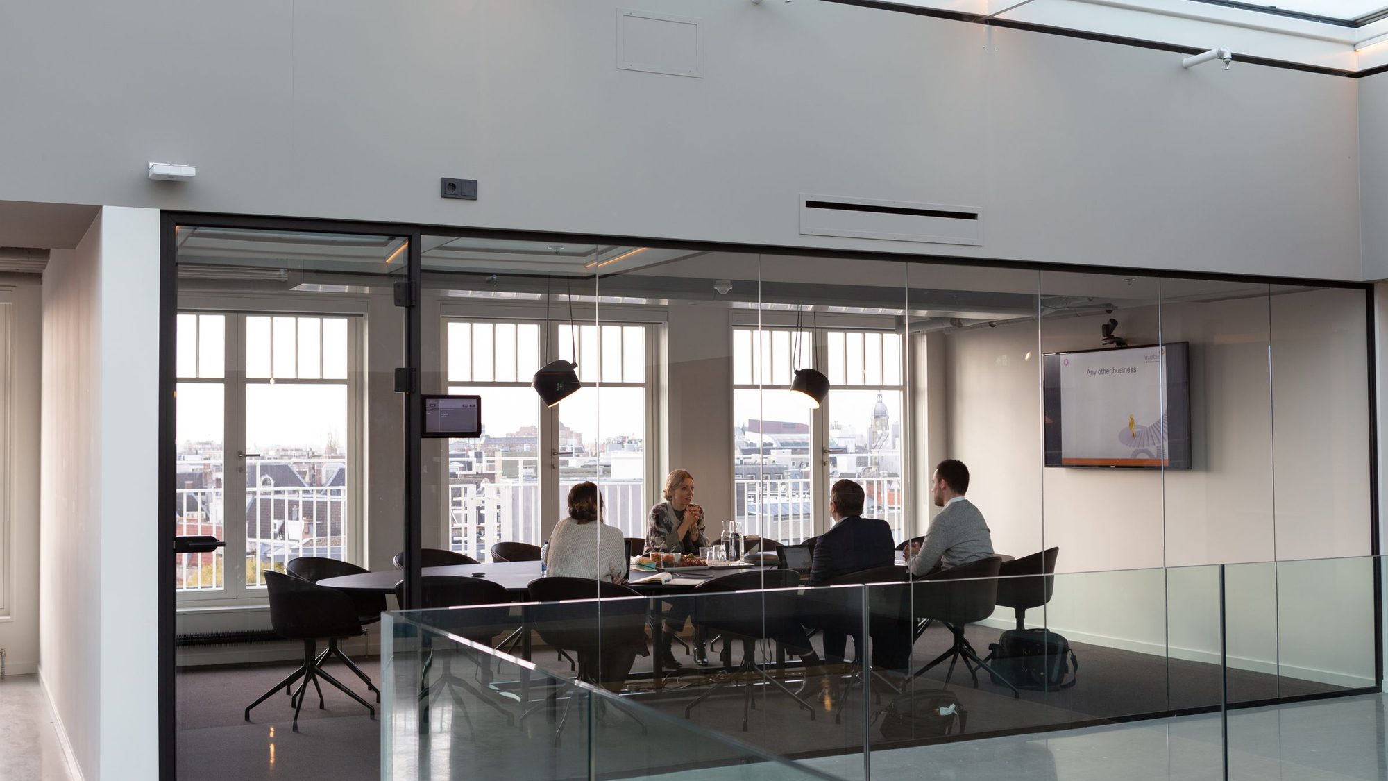 A meeting in a glass-walled modern office