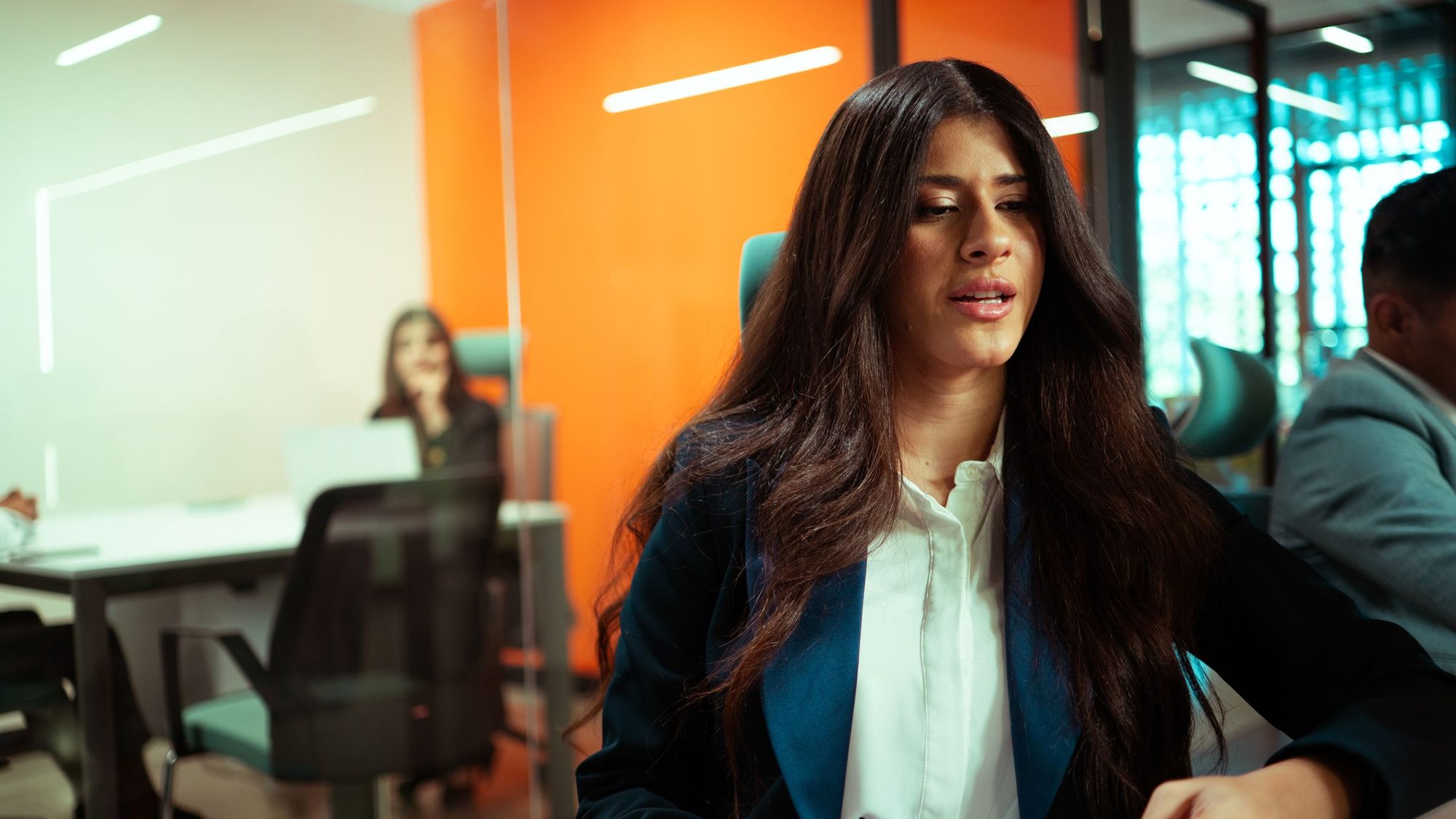 Two colleagues talking in a modern workplace